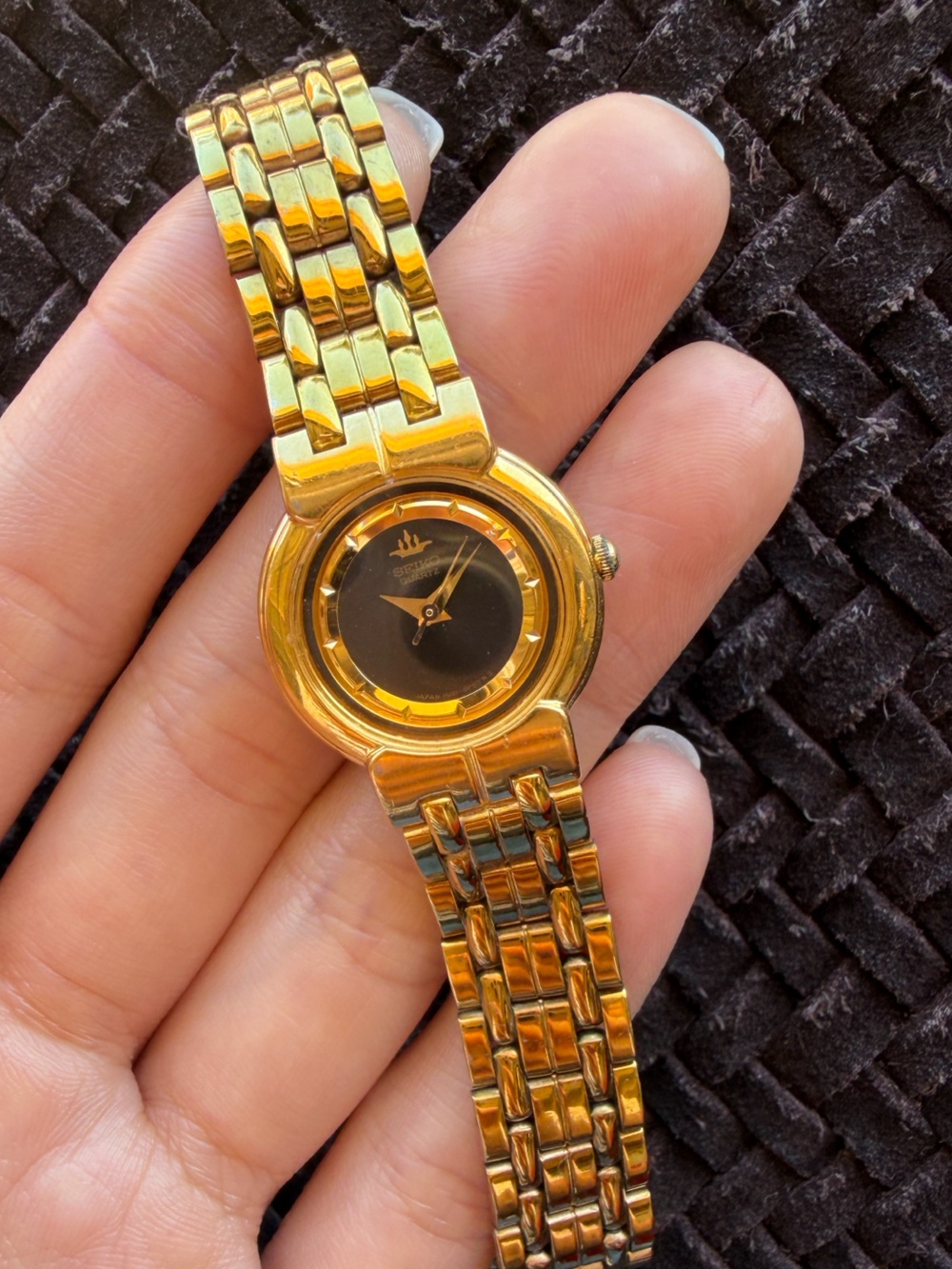 Seiko gold watch with black face dial